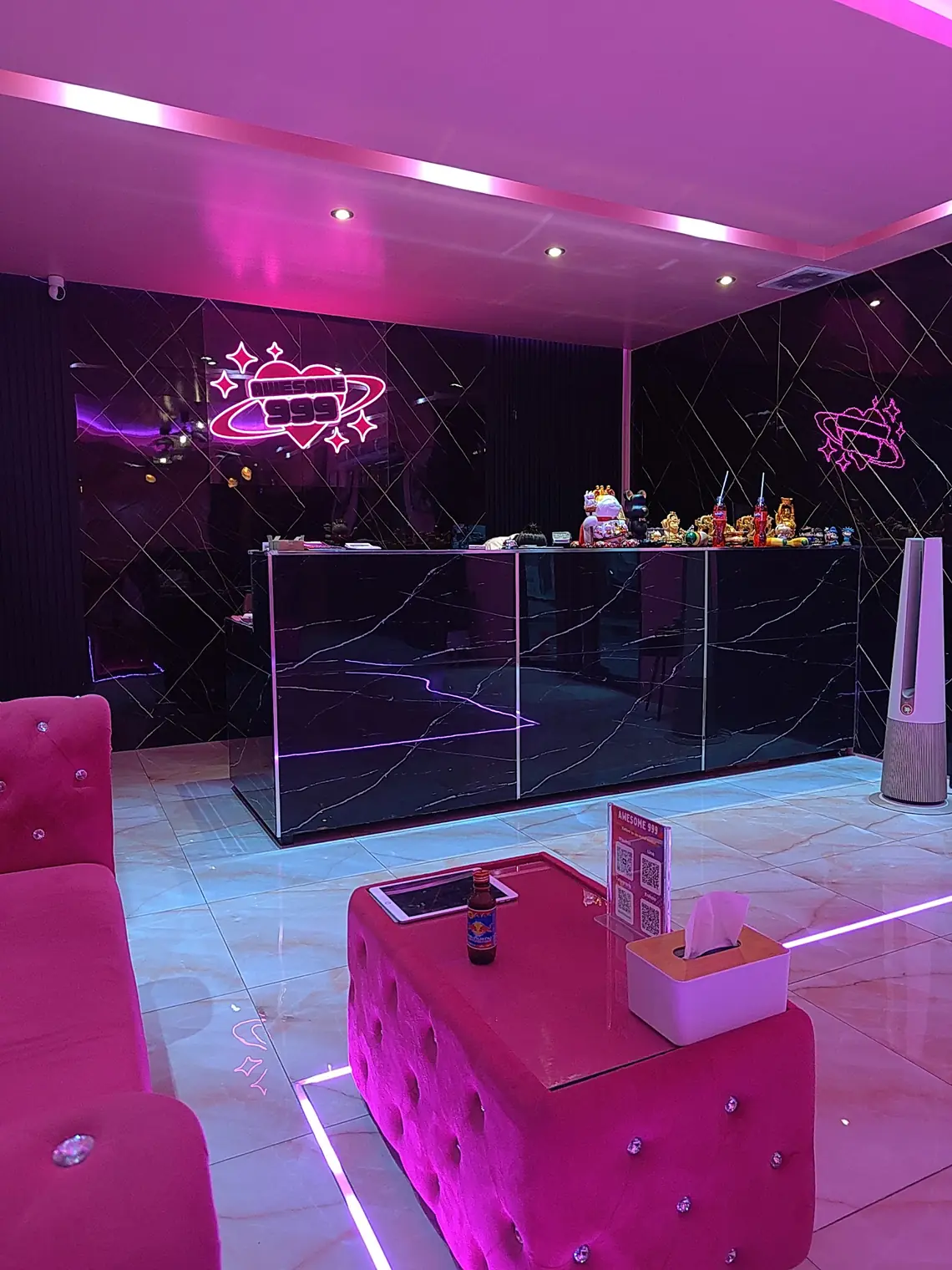Awesome999 Nuru Massage: reception with the neon logo